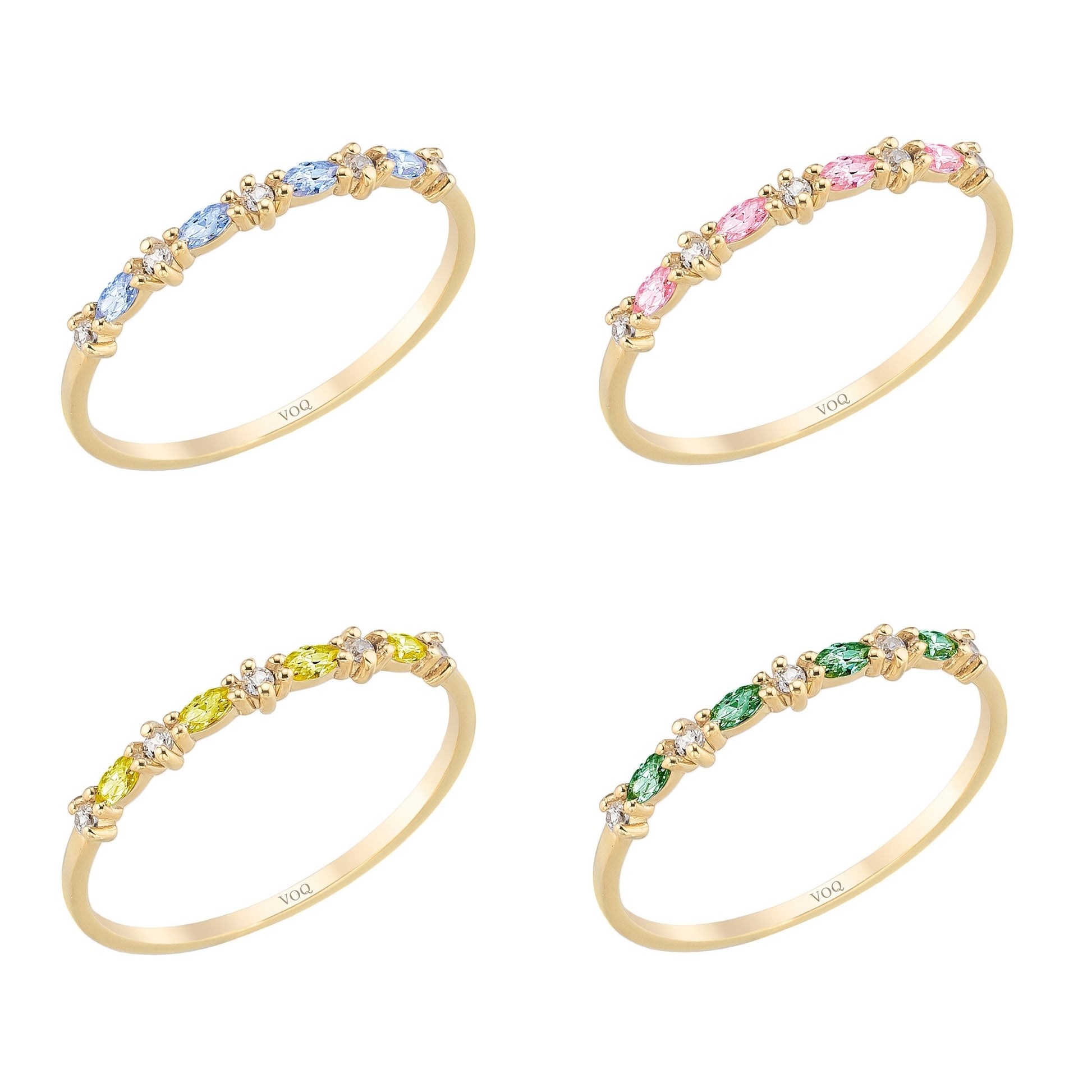 four gold rings with colorful gemstones, each with a unique color and pattern.