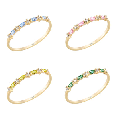 four gold rings with colorful gemstones, each with a unique color and pattern.
