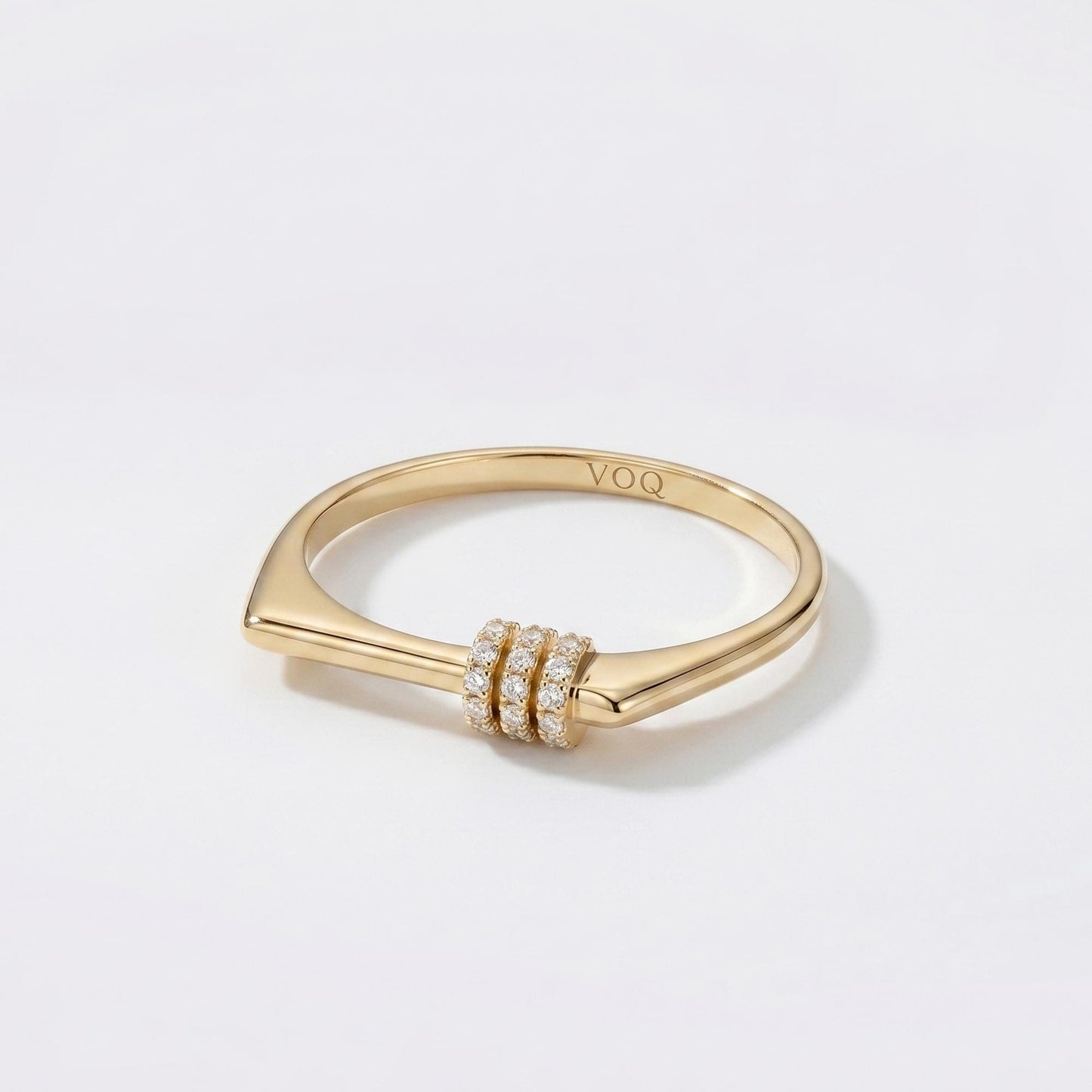 A gold ring with a diamond-encrusted band and a small, round gemstone.