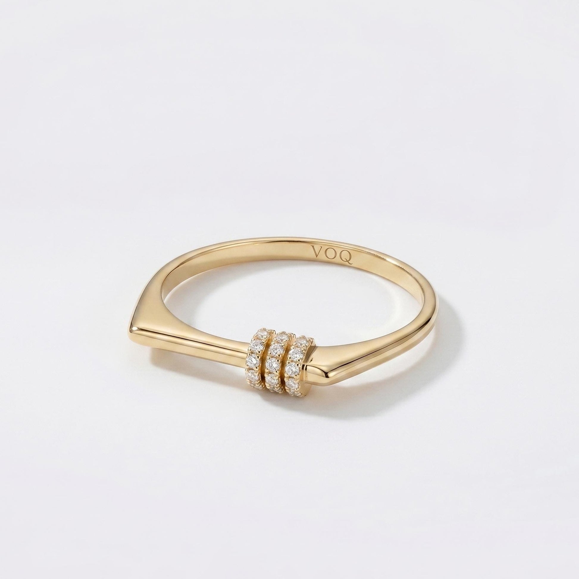 A gold ring with a diamond-encrusted band and a small, round gemstone.