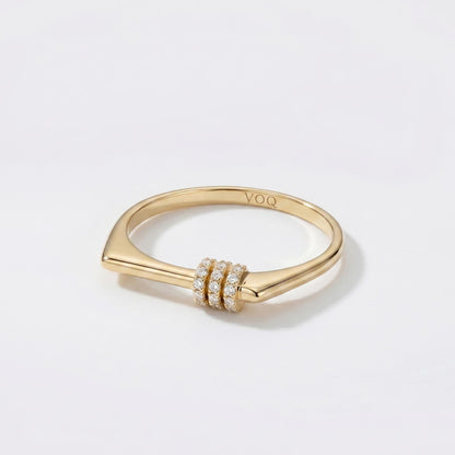 A gold ring with a diamond-encrusted band and a small, round gemstone.