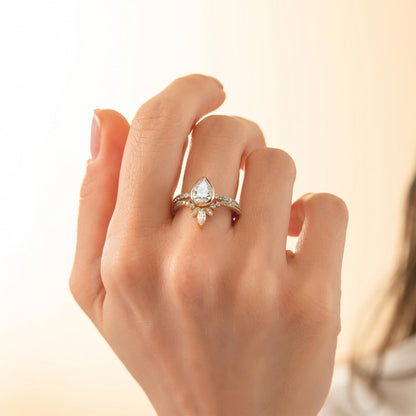 A close-up of a hand wearing a diamond engagement ring with a large central diamond and smaller diamonds around the band.