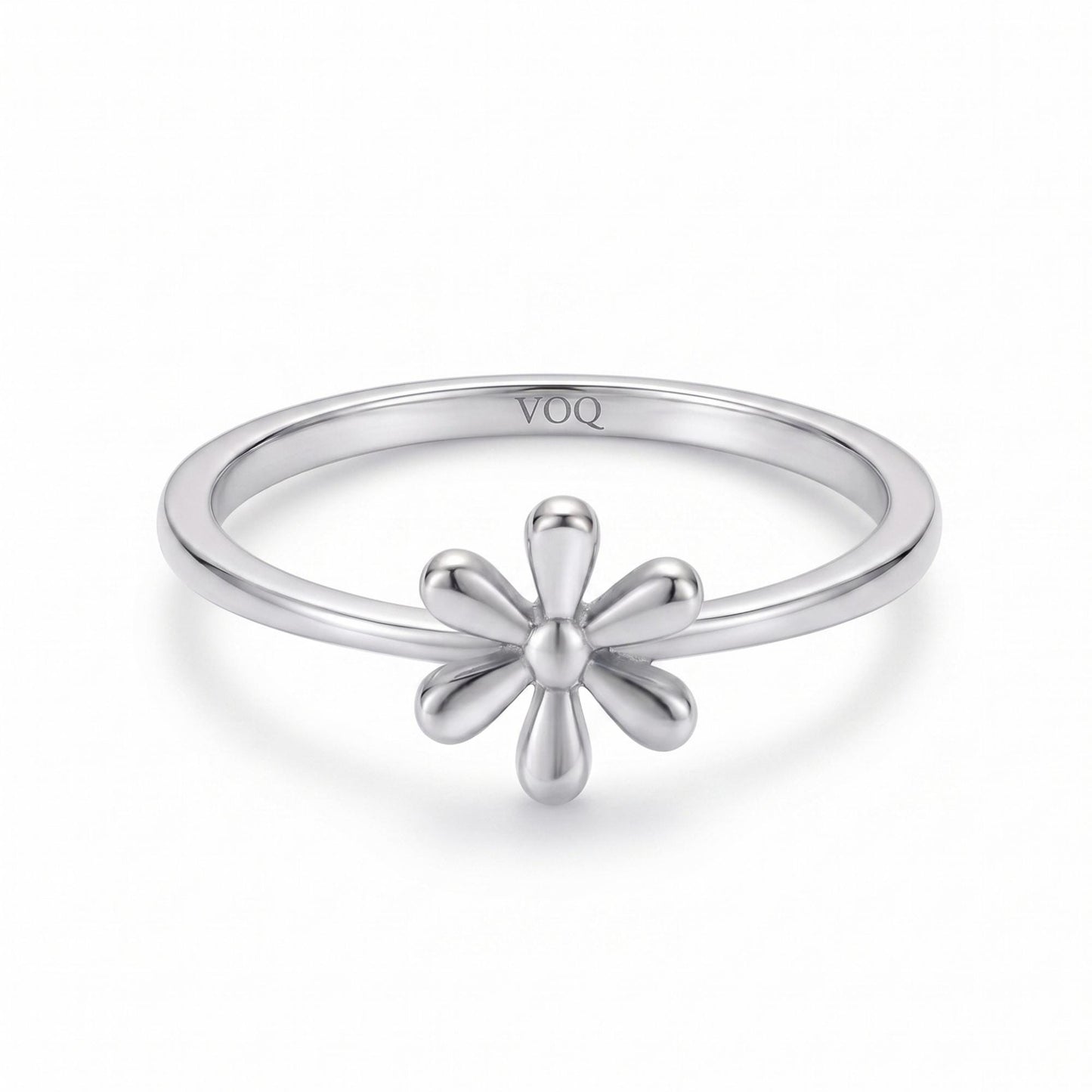 A silver ring with a flower-shaped gemstone in the center.