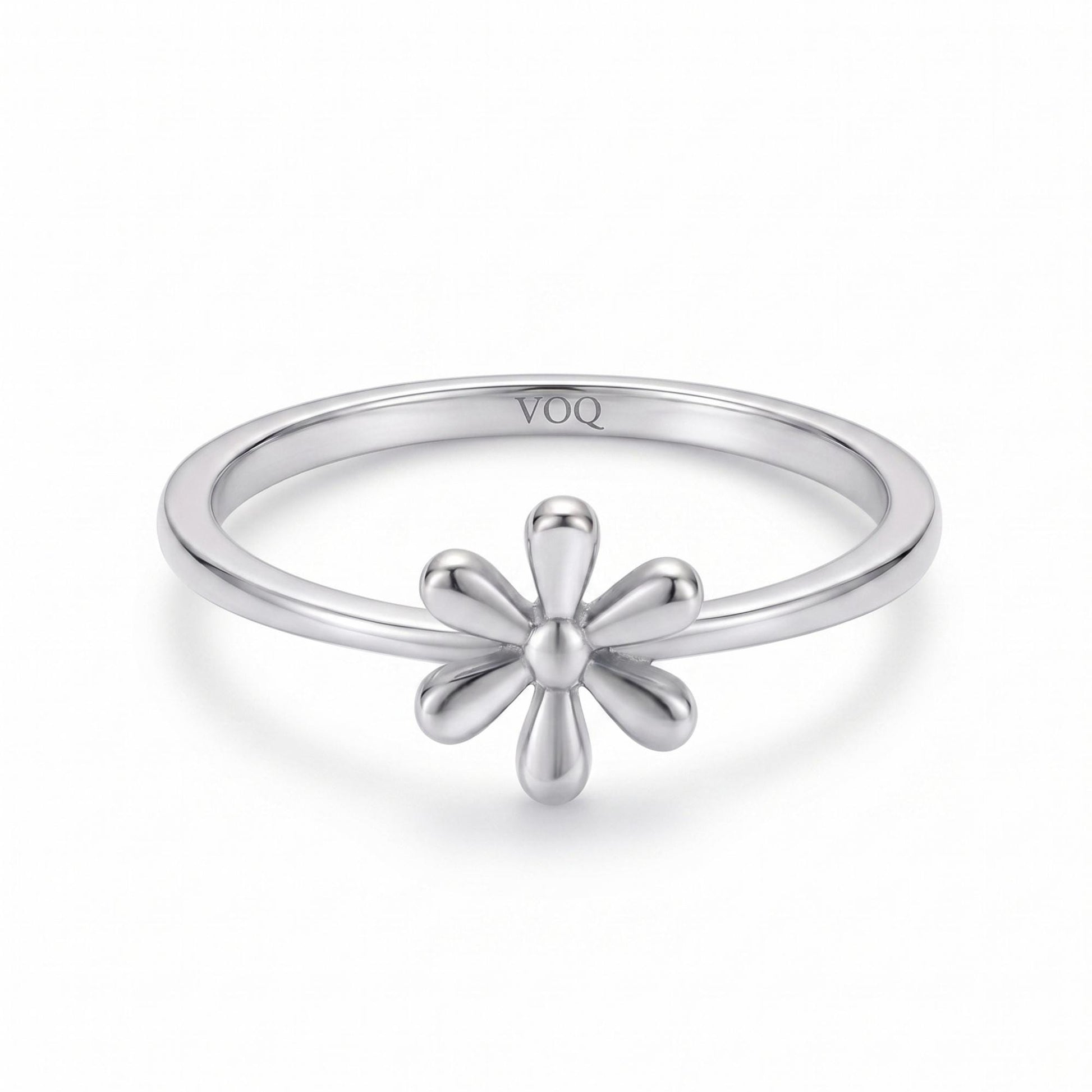 A silver ring with a flower-shaped gemstone in the center.