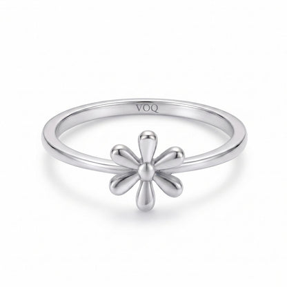 A silver ring with a flower-shaped gemstone in the center.