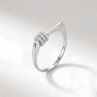 A silver ring with a diamond cluster on the band.