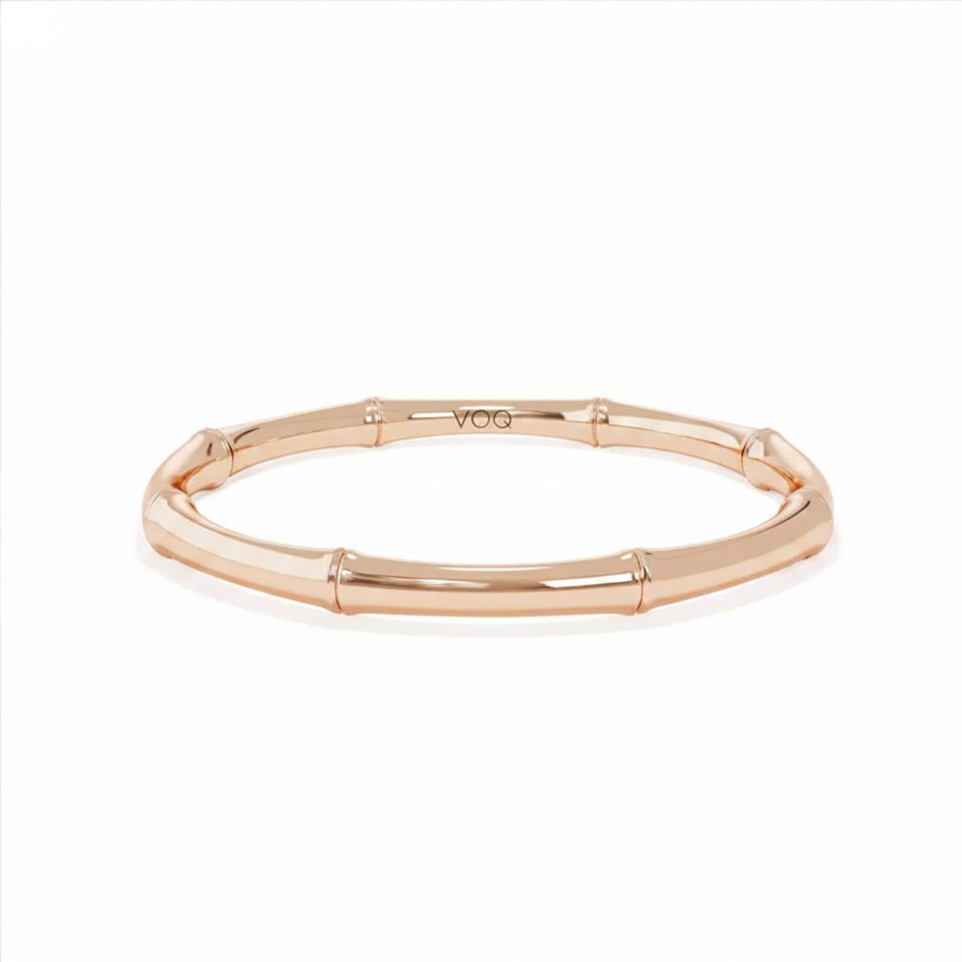 A gold-colored bracelet with a curved design.