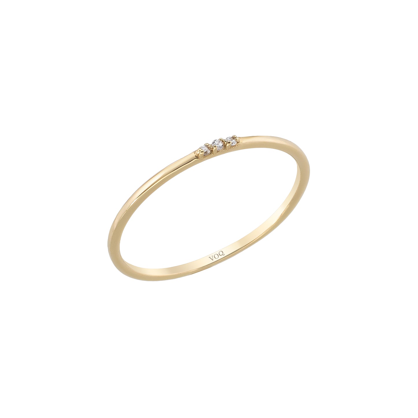 A simple gold ring with three small diamonds set in the center.