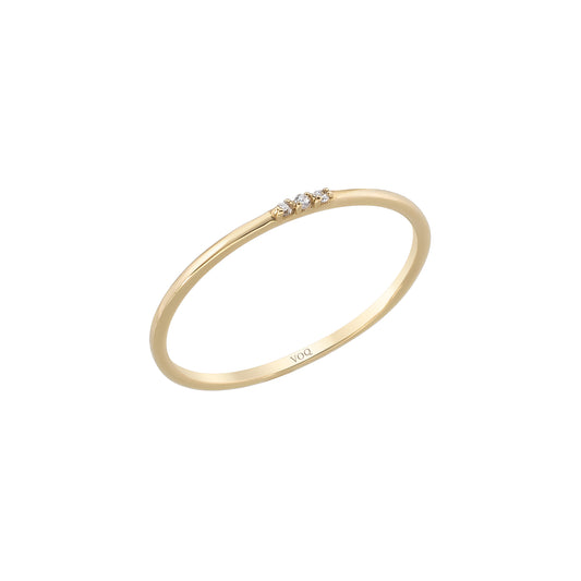 A simple gold ring with three small diamonds set in the center.