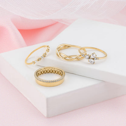 a collection of gold rings and jewelry, including a ring with a diamond band and another ring with a diamond band and a small diamond.