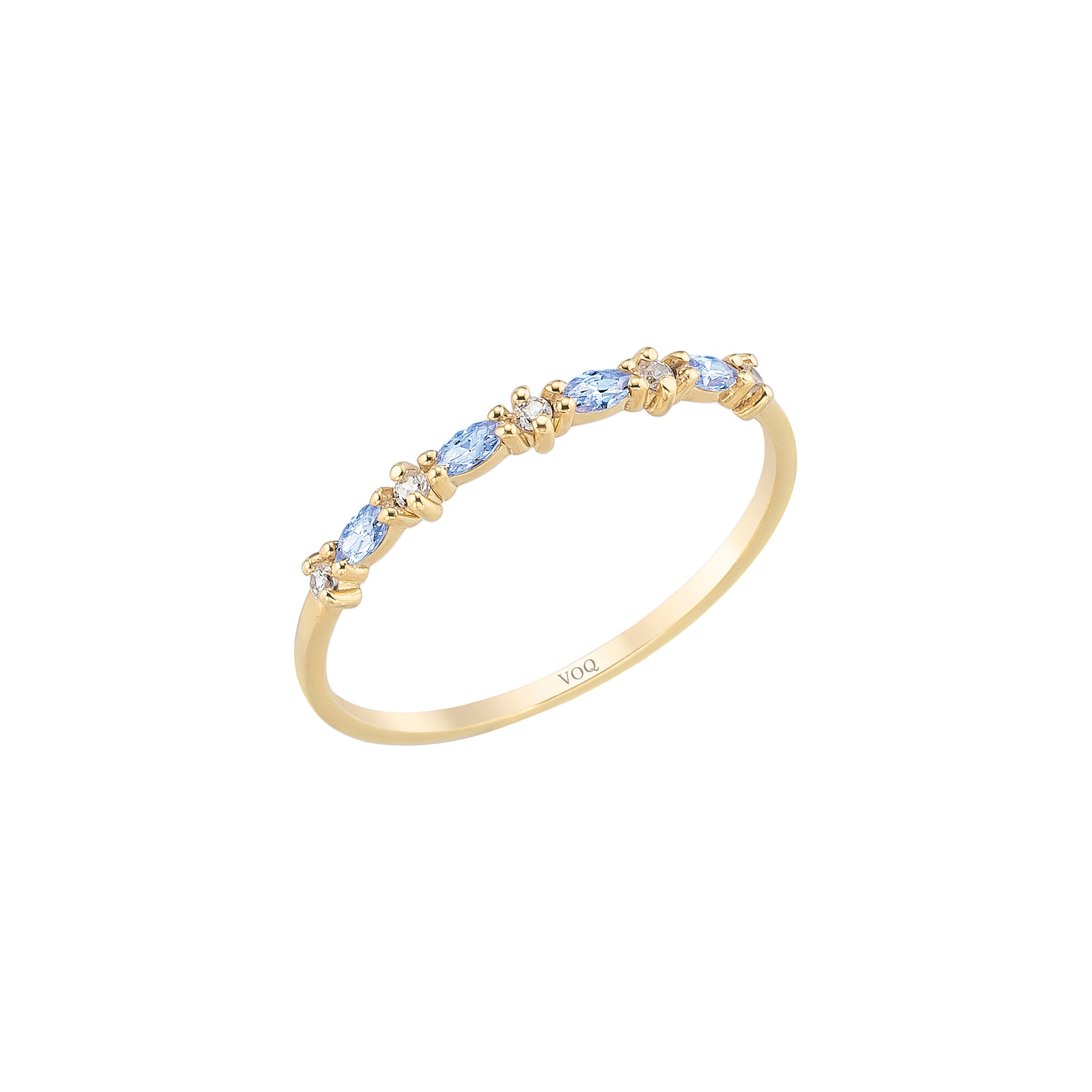 A gold ring with a row of blue gemstones on the band.