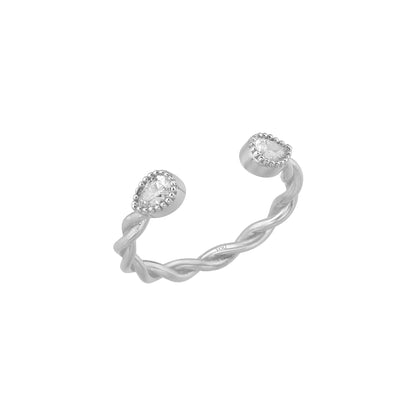 A silver ring with a twisted design and two small, clear gemstones on either side.