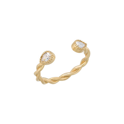 A gold ring with a twisted design and two small diamonds set in the center.