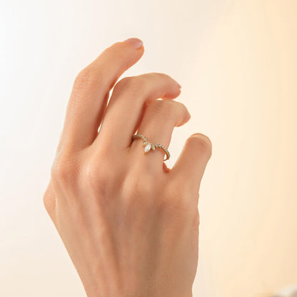 A close-up of a hand wearing a ring with a small diamond.