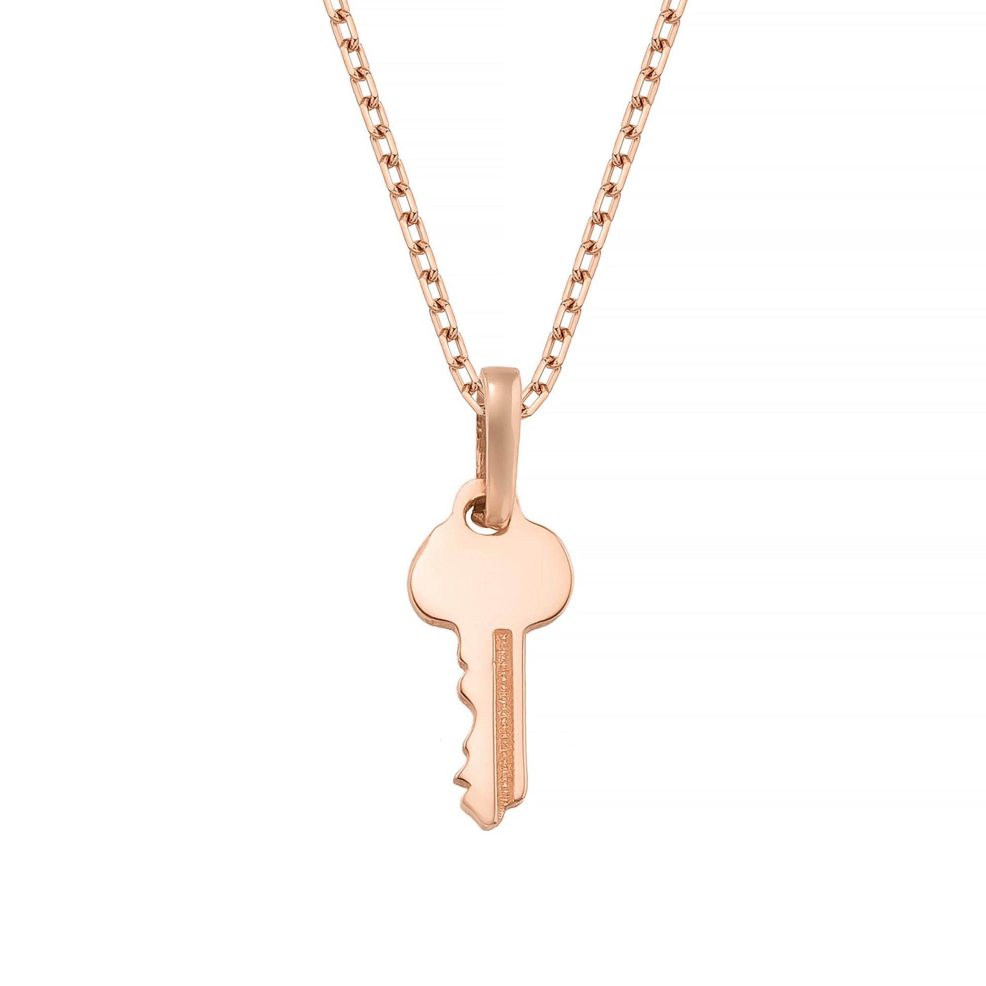 A delicate rose gold-colored necklace with a single key-shaped pendant.