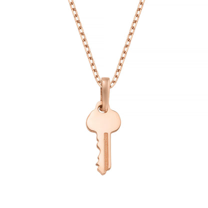 A delicate rose gold-colored necklace with a single key-shaped pendant.