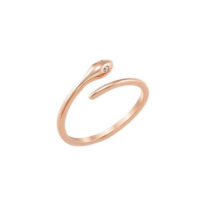 A gold-colored ring with a snake-like design and a small gemstone.