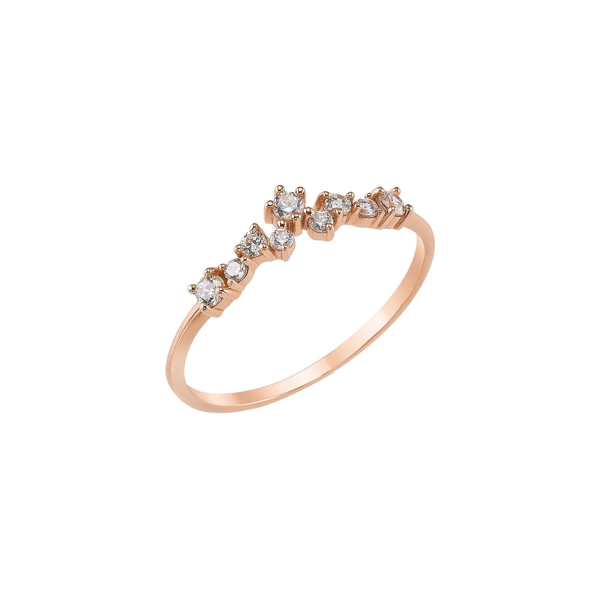 A rose gold ring with a row of small diamonds set in a decorative pattern.
